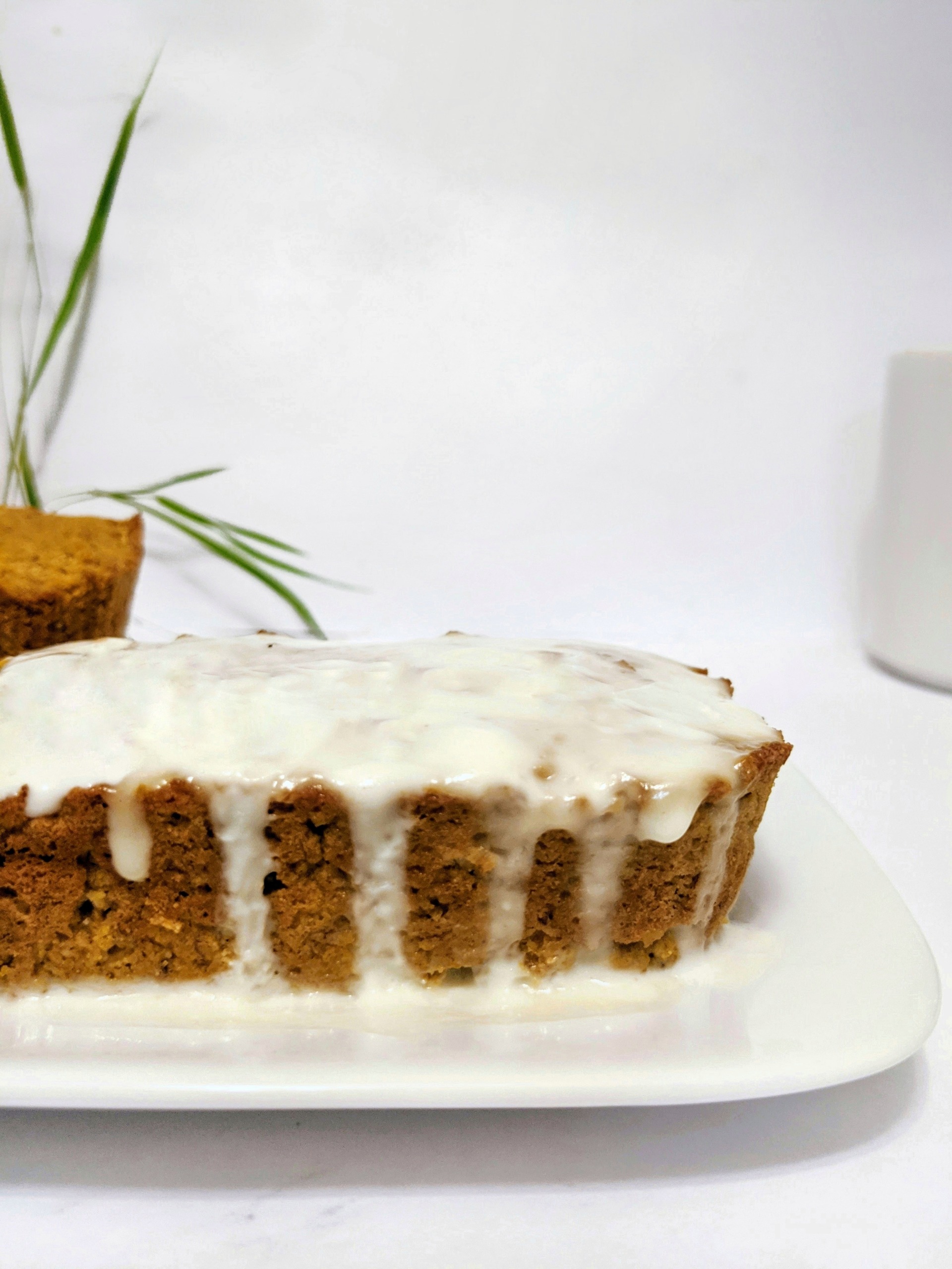 This Paleo Pumpkin Banana Bread a mashup of two classic quick breads made with coconut flour and topped with a protein-yogurt glaze. With the moist tenderness of a banana bread, and warmth of a pumpkin bread, this loaf will be your new favorite.
