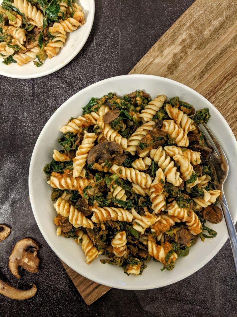 This Pumpkin Pasta with Mushroom & Kale is truly fall-dinner perfection! A healthy and whole pasta tossed with superfoods and coated in a creamy, delicious pumpkin sauce.
