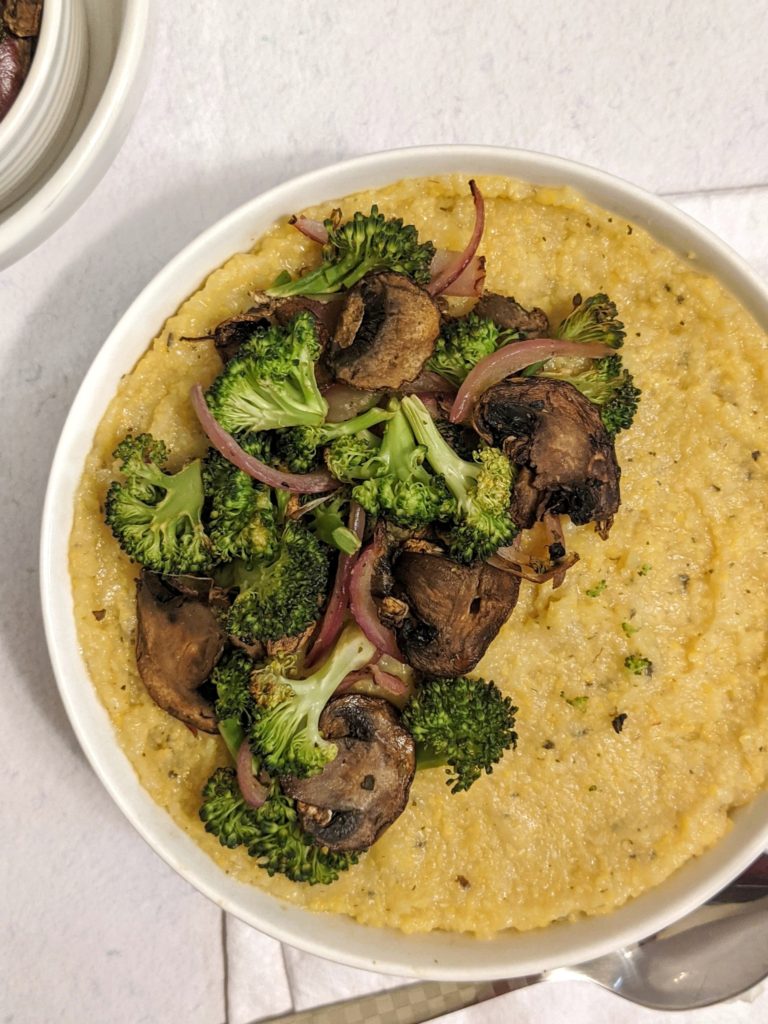 Cut and cook tubed polenta on a stove to make this creamy vegan polenta with broccoli and mushrooms. Made cheesy with nutritional yeast.