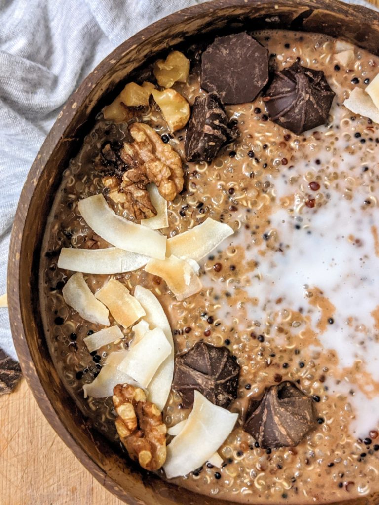 A large Chocolate Coconut Quinoa Breakfast Bowl for a filling, nutritious and delicious meal to start your day. This healthy grain-free porridge uses coconut milk, making it a great Vegan option too!
