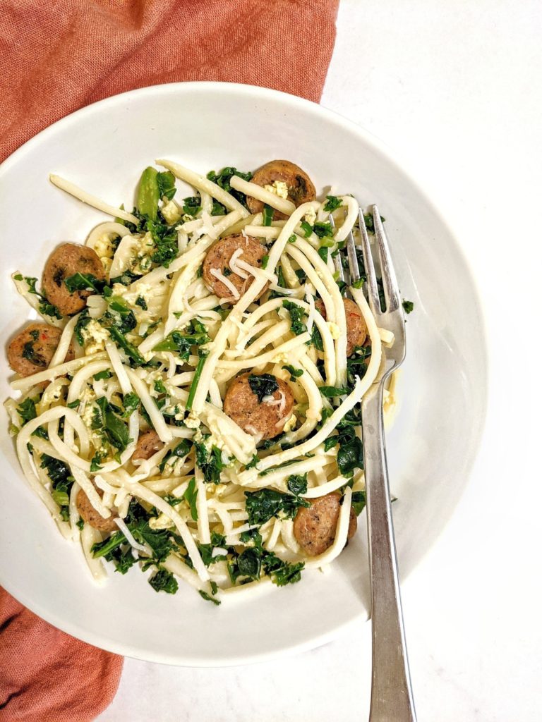 A healthy keto, low carb and gluten free spaghetti carbonara made with Palmini hearts of palm noodeles. Its tossed in a cheese egg sauce with kale and sausages for an easy keto pasta dinner!