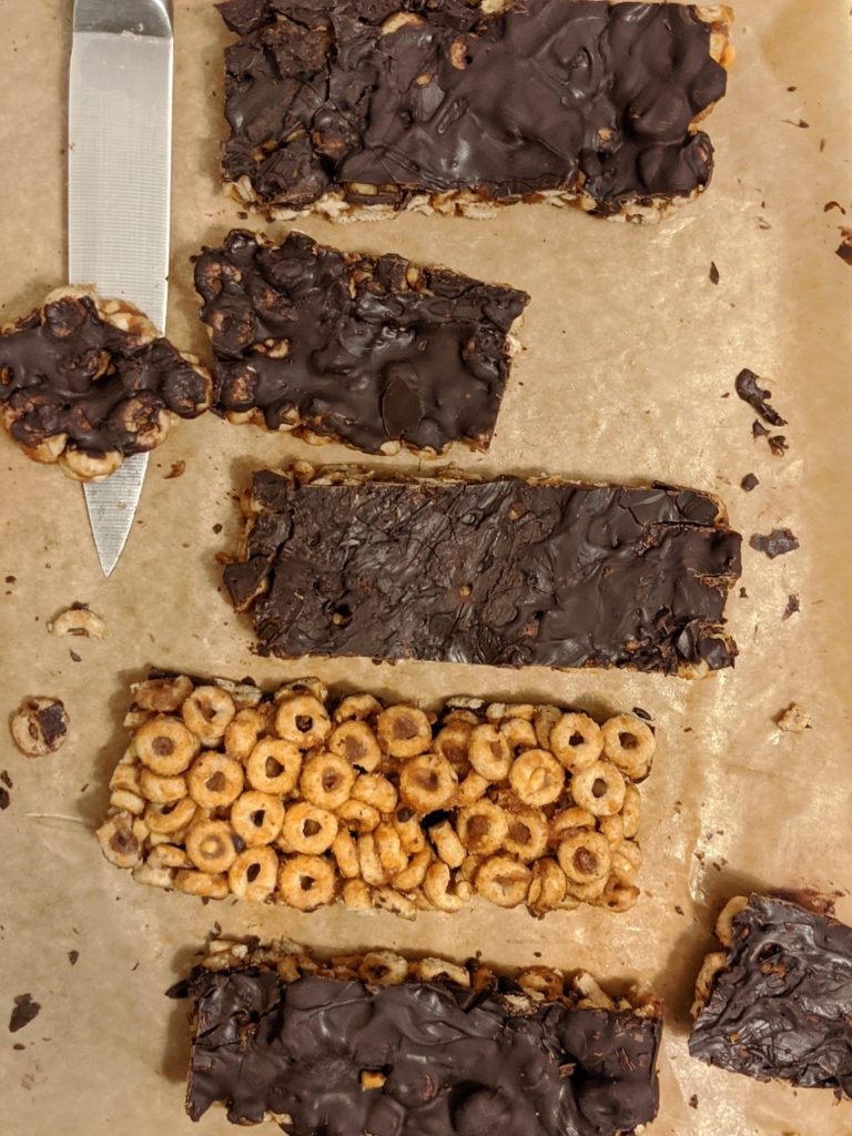 A recipe for gluten free and healthy no bake homemade chocolate peanut butter bars made with cheerio cereal, chocolate, creamy peanut butter and maple syrup