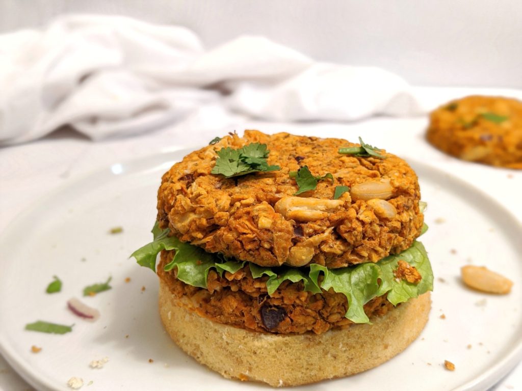 Healthy homemade veggie burgers made with white beans, carrots, cumin and a ton of other spices to make the best spicy vegetarian burger!