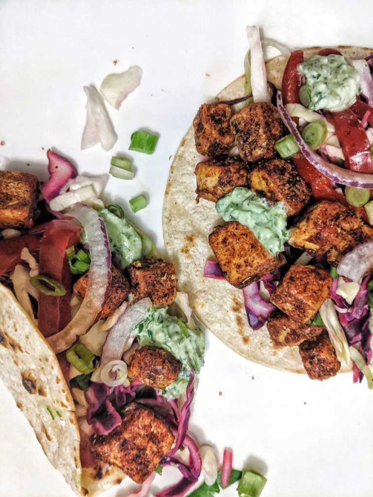 Spicy vegetable tacos with tofu, slaw, vegetables and tortillas!