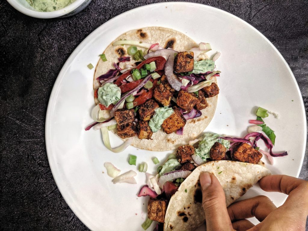 Easy spiced veggie tacos loaded with chunks of tofu for a high protein vegetarian meal without any beans or avocado.