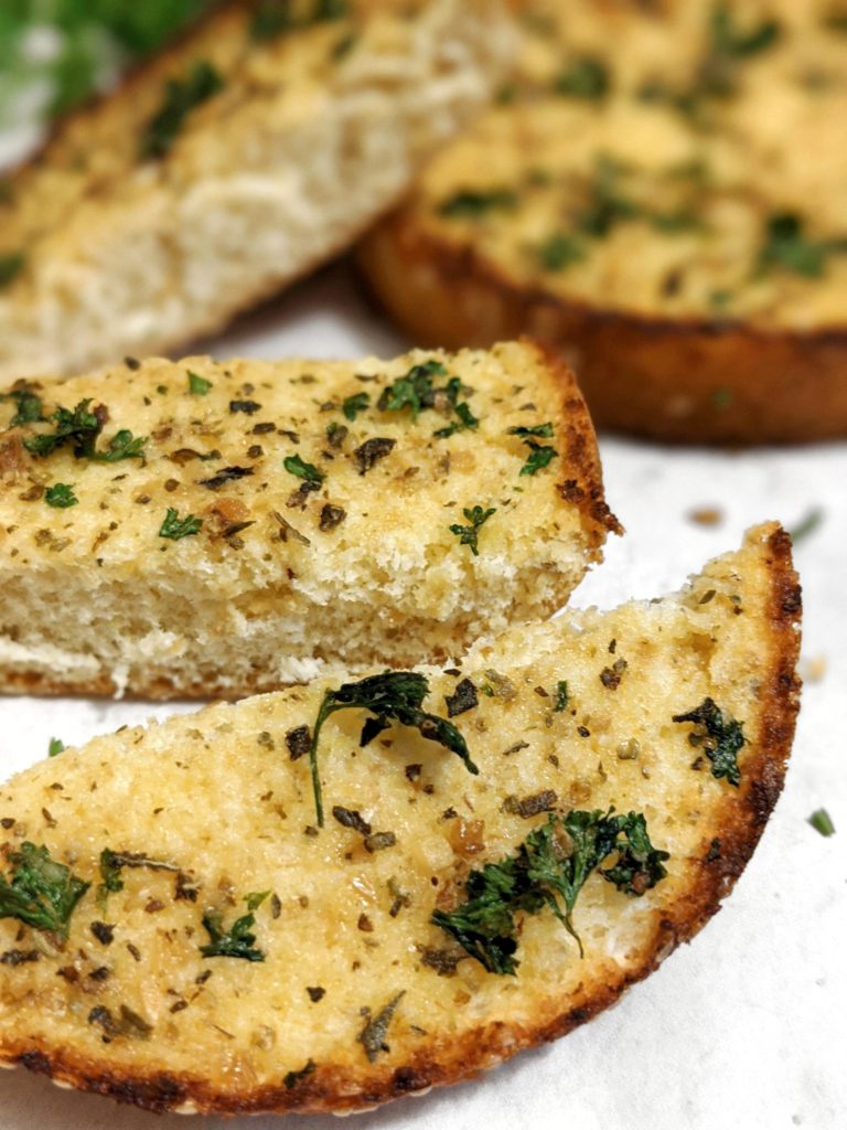 Use this easy recipe to learn how to make homemade garlic bread with hamburger buns, butter, garlic powder, minced garlic, olive oil and parsley. Baked in the oven or cooked in an air fryer.