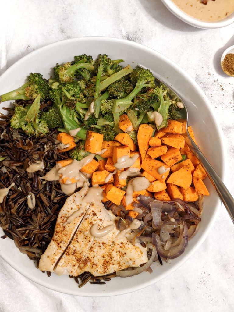 The perfect peanut butter chicken buddha bowl with healthy wild rice grain and roasted sweet potato and broccoli.