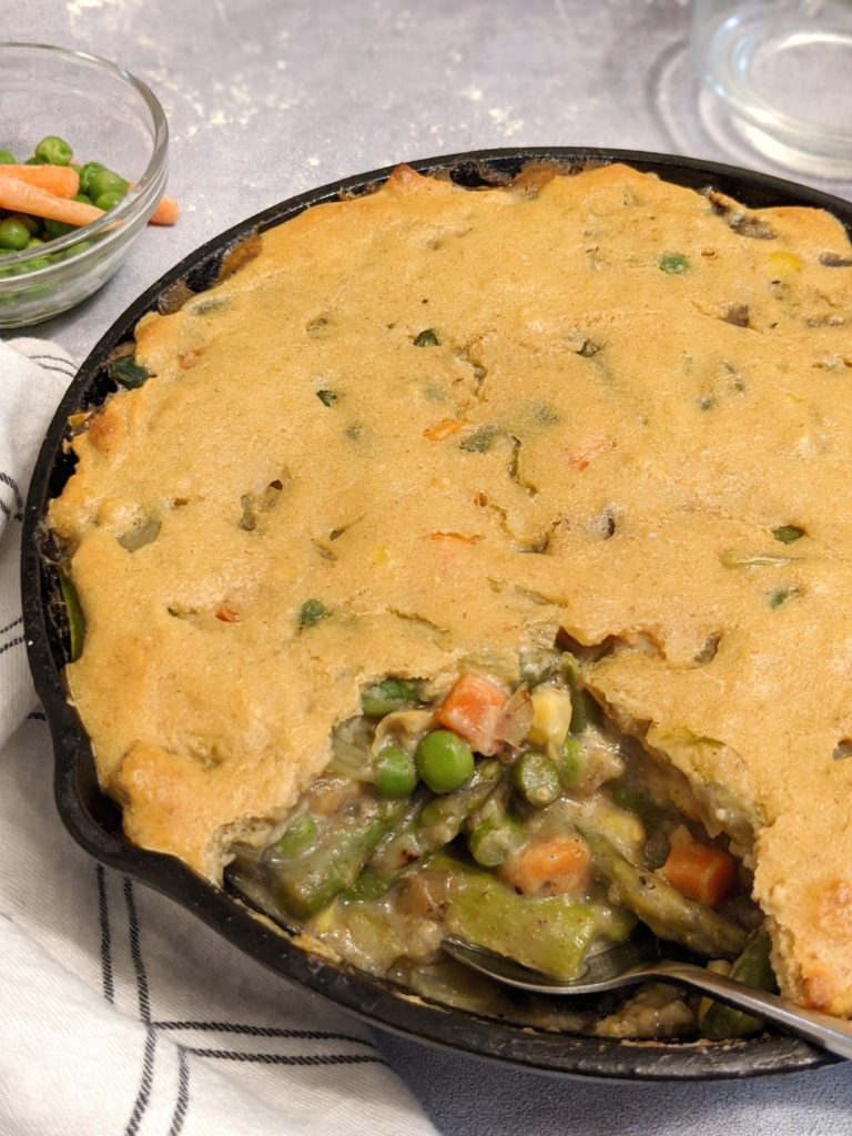 A healthy easy vegetarian veggie-loaded pot pie with a simple and brunchy bisquick crust on top.
