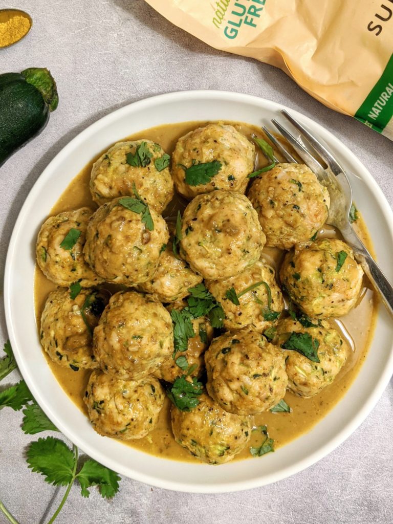 Flavor-packed bites of Curry Chicken-Zucchini Meatballs coated in a delicious Coconut Curry Sauce! Held together with almond flour, these spiced, juicy and nutritious meatballs are Paleo and Keto-friendly too!