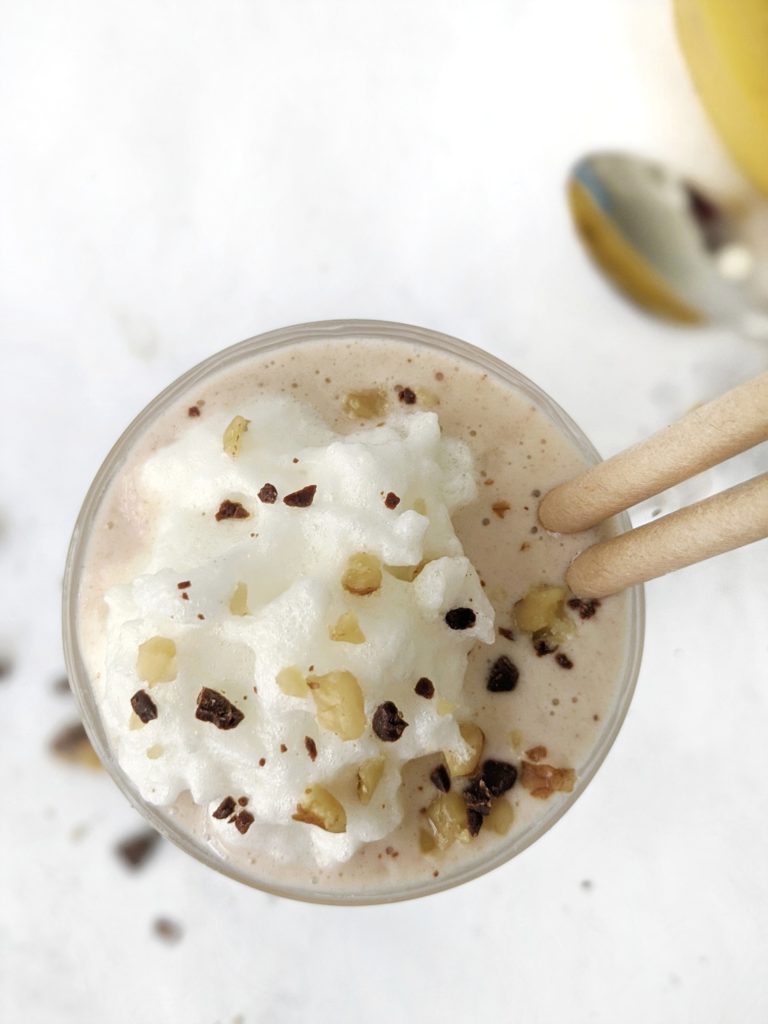 Make this healthy frozen banana milkshake topped with walnuts and chocolate using coconut yogurt, without ice cream, and no peanuts or peanut butter for a sugar free, vegan and paleo friendly protein shake. 
