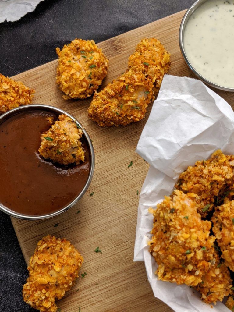 An easy gluten free baked chicken breast nuggets coated with cornflake crumbs, almond flour and homemade cajun seasoning for a crunchy and crispy dish without a deep fryer!