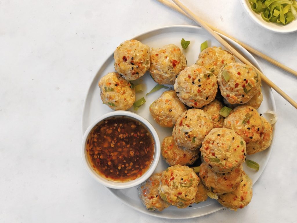 The best egg roll chicken meatballs recipe made with no egg, no flour, no breadcrumbs, no parmesan, and then baked in the oven (or air fryer) and paired with a sugar free sweet chili sauce for a healthy dinner!
