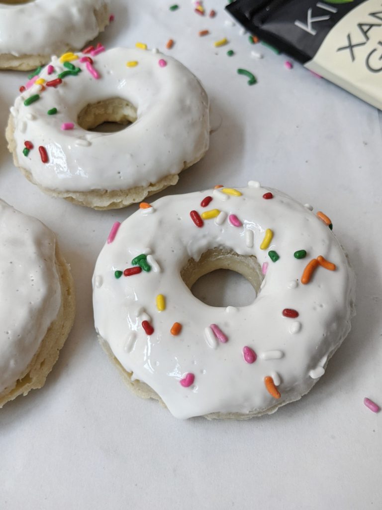 Healthy baked vanilla glazed donuts made with gluten free flour and and a bit of xanthan gum for a delicious homemade doughnut complete with a greek yogurt icing.
