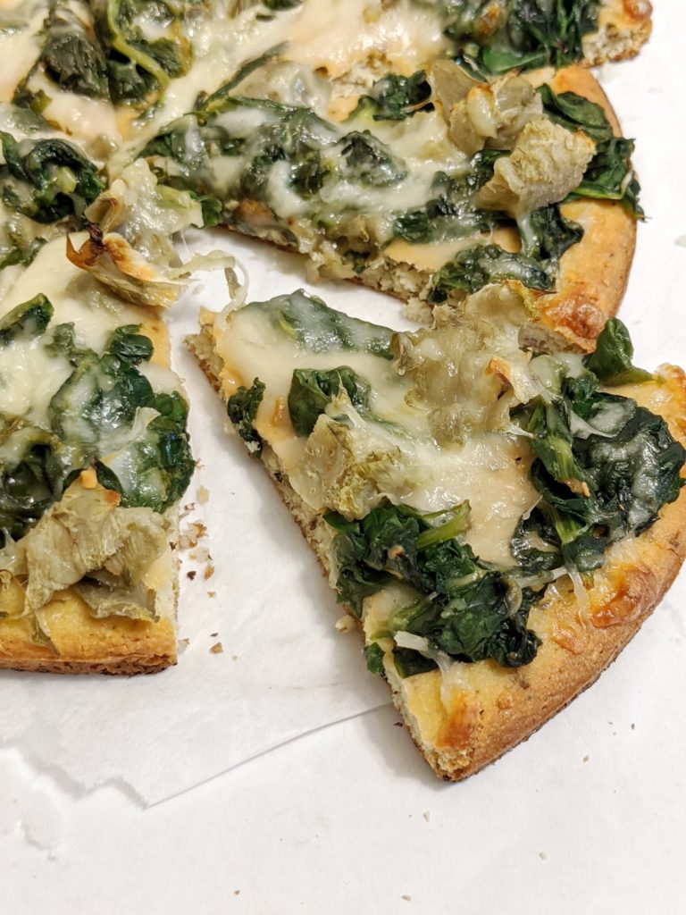 Easy, cheesy and super delicious, this Spinach Artichoke White Cheese Pizza is tastes like the creamy dip, if not better! Made with just a few simple ingredients, reduced fat mozzarella and no sauce, this pizza is great for a healthy Friday-night indulgence!