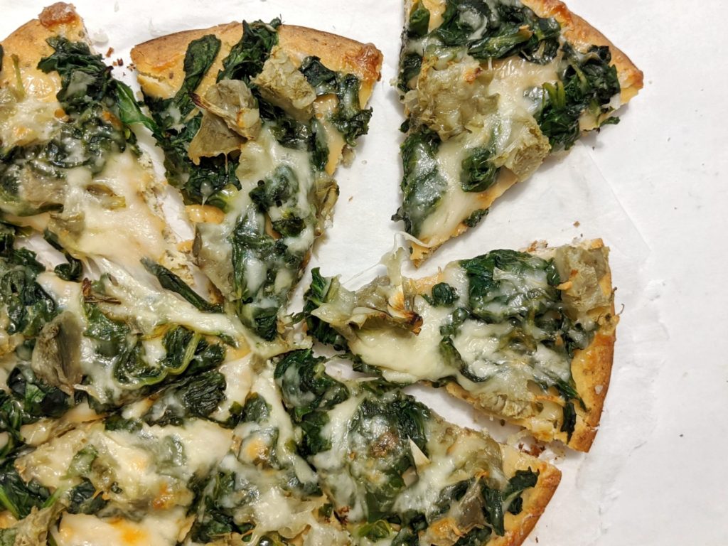A healthy easy and homemade white spinach artichoke and cheese pizza made without sauce and no flour either for a no carb recipe!