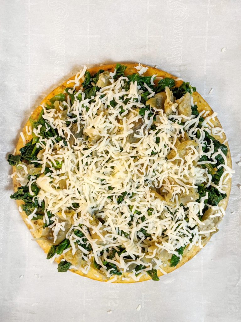 This gluten free, low carb and keto friendly spinach artichoke cheese pizza can made with a cauliflower crust or gluten free crust.