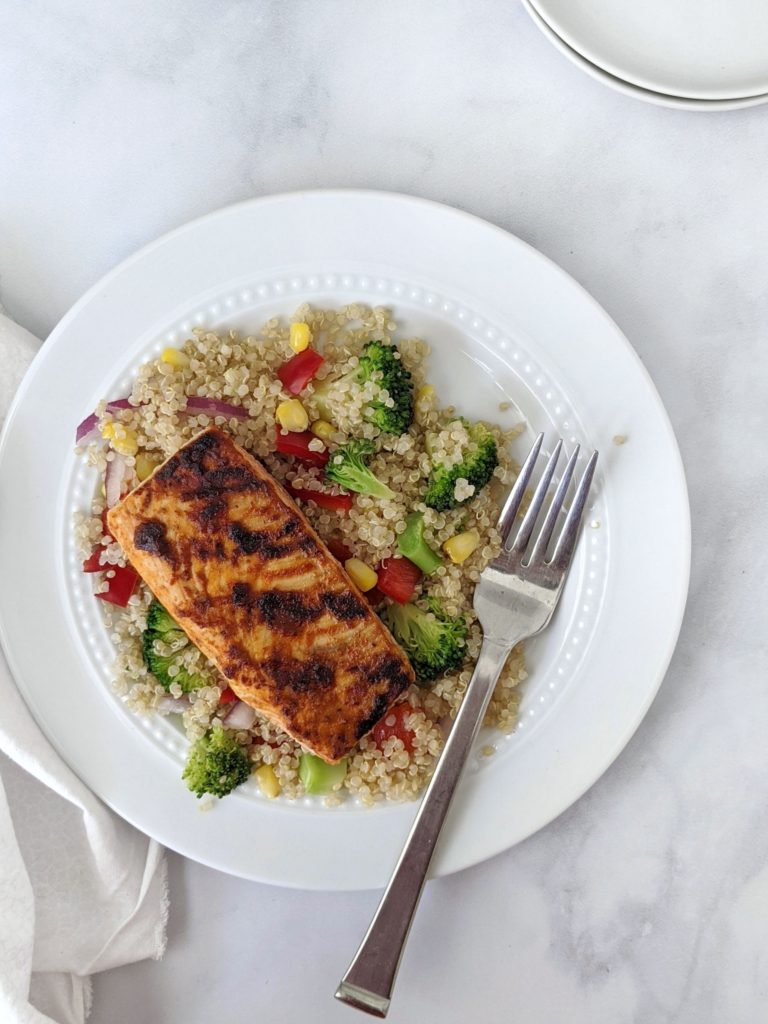 Tangy BBQ Glazed Salmon Quinoa Salad with seasoned broccoli, peppers, onion and corn. BBQ grilled salmon or pan seared, this healthy quinoa recipe makes an easy lunch or dinner and tastes great hot or cold!