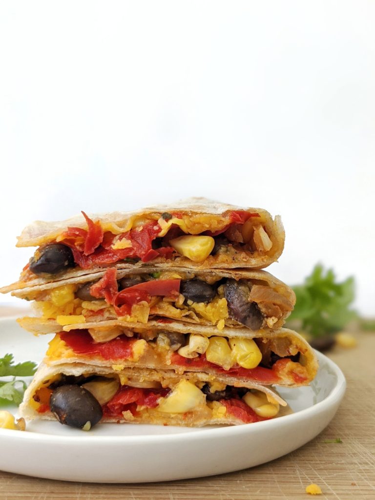 Bright and beautiful Black Bean and Corn Quesadillas full of fiber, flavorful spices and cheesy goodness! A perfect vegetarian recipe for an easy and filling lunch.
