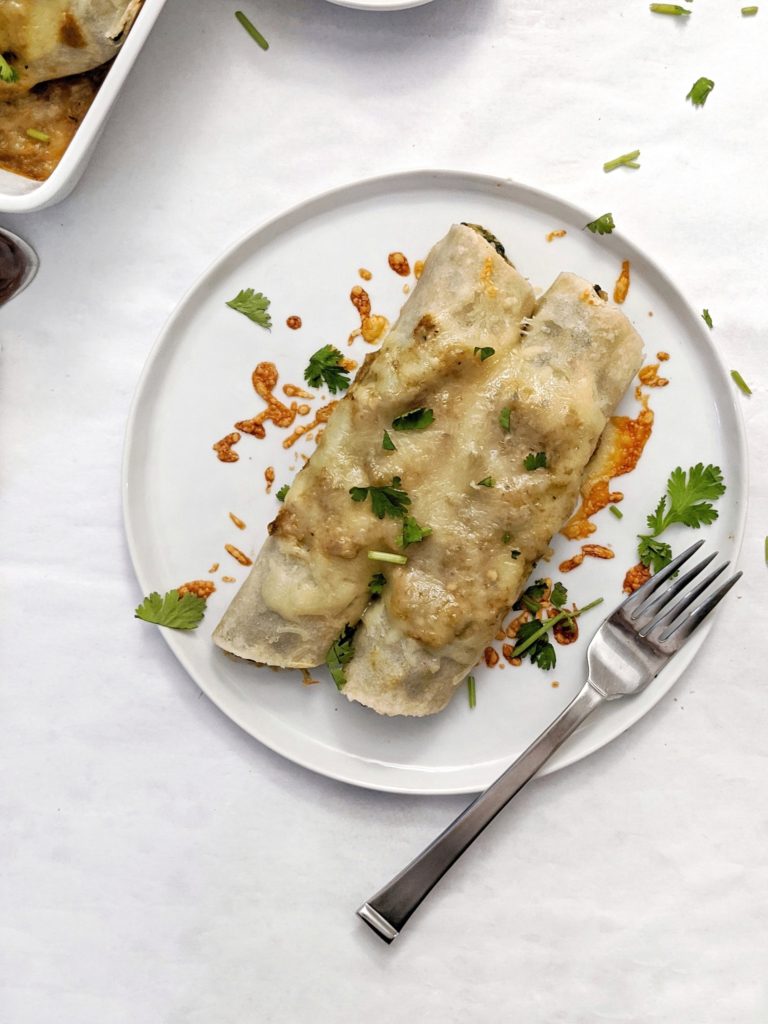 Healthy Green Chile Chicken & Spinach Enchiladas with a flavorful protein-packed filling, homemade salsa verde and topped with bubbly cheese. The perfect comfort food for a night in!