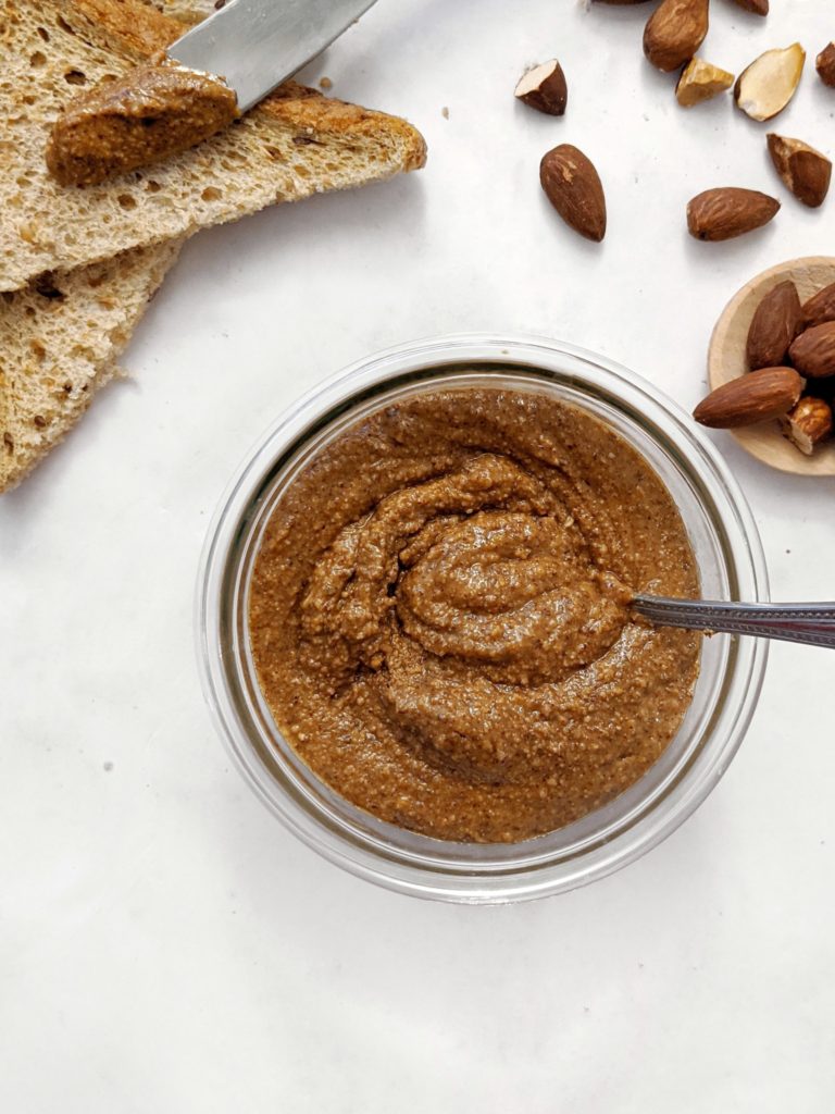 A super easy recipe for Homemade Creamy Roasted Almond Butter with no added oil! Made with only almonds, you can add in sweeteners, spices or vanilla to make this smooth spread to suit your liking.