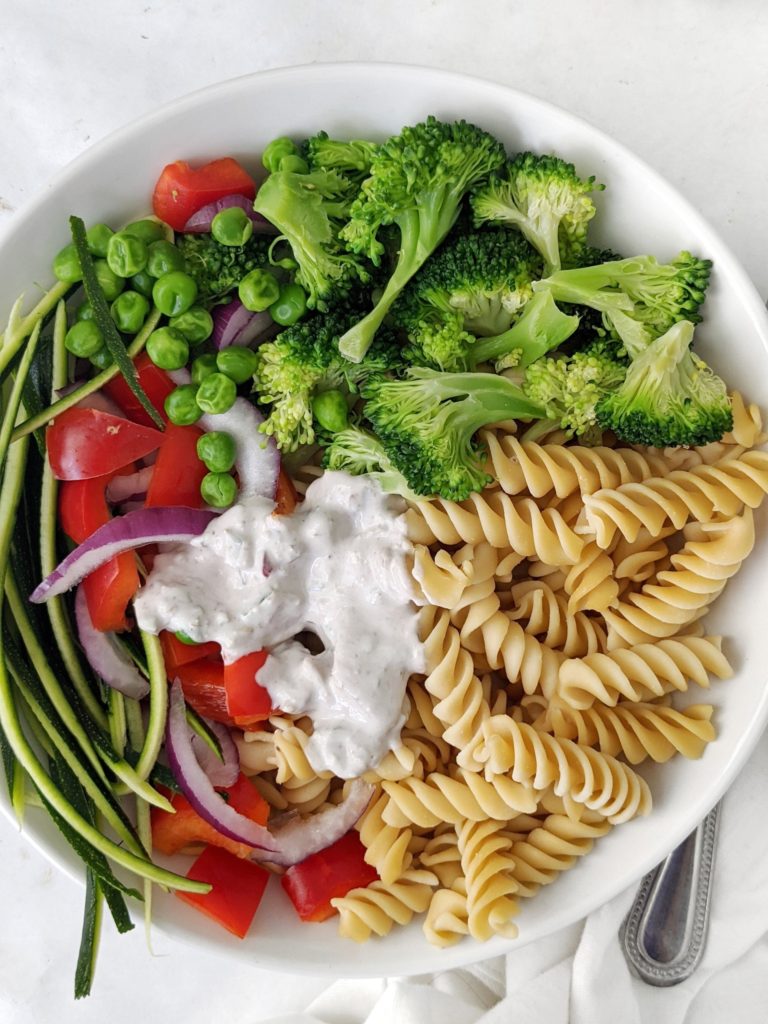 A healthy and creamy vegetarian and vegan veggie pasta salad made with yogurt and tahini dressing but no mayo and no oil or cheese either!