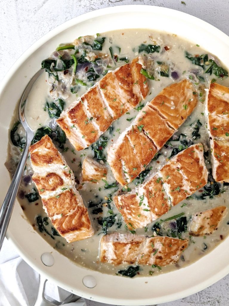 Easy Garlic Parmesan Creamed Spinach Salmon for a restaurant quality dinner at home. Pan seared salmon smothered in a cheesy, garlicky, creamy spinach sauce. A delicious and healthy dinner in 20 minutes.