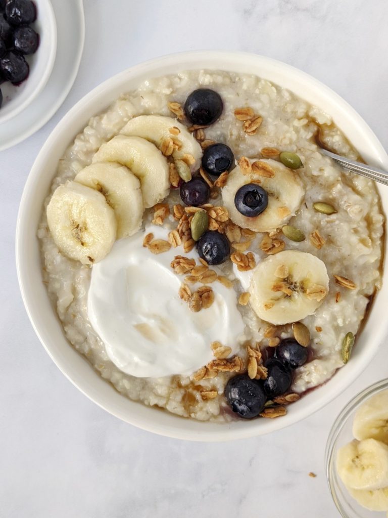 Sweet and Creamy Greek Yogurt Protein Oats made with non-fat greek yogurt and vanilla protein powder, and topped with fruit - like having a warm bowl of parfait! A nutritious, filling and delicious breakfast that’s easy to meal prep too.