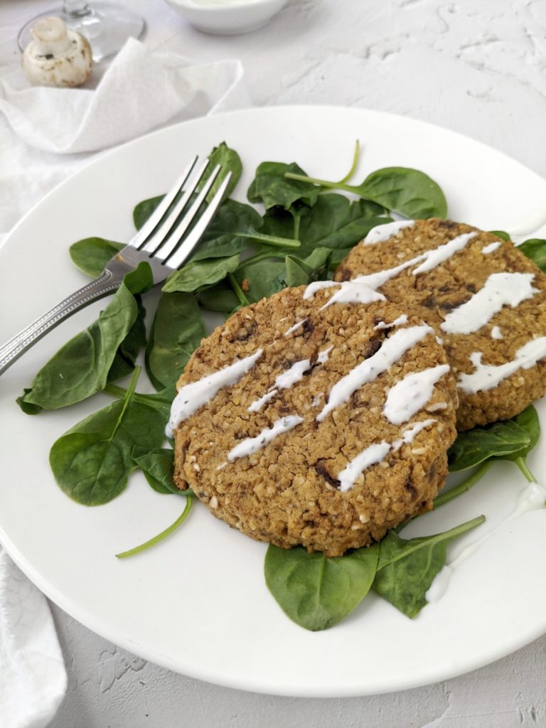 Healthy Baked Mushroom Lentil Patties paired with a zesty Tzatziki sauce - A delicious, protein-packed Vegan recipe. Bound together with oats, these patties are gluten-free, and are perfect for an appetizer, or even a veggie burger!