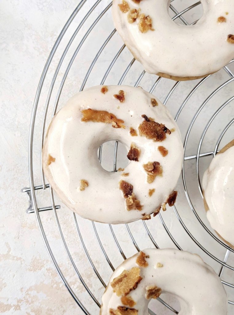 Soft and Fluffy Maple Bacon Protein Donuts with a perfect balance of sweet maple glazed donuts with salty bacon pieces inside and out! These baked doughnuts are made with gluten free flour, vanilla protein powder and greek yogurt, for a gluten-free, sugar-free and high protein indulgence!