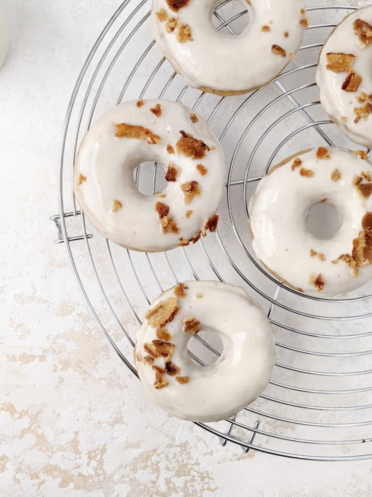 Soft and Fluffy Maple Bacon Protein Donuts with a perfect balance of sweet maple glazed donuts with salty bacon pieces inside and out! These baked doughnuts are made with gluten free flour, vanilla protein powder and greek yogurt, for a gluten-free, sugar-free and high protein indulgence!