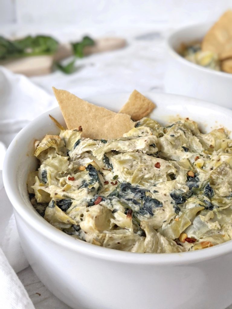 Cheesy but healthy Hot Spinach Artichoke Dip made with low fat cream cheese and Greek yogurt for the same amazing taste with lower calories! Serve this warm baked dip with tortilla chips for a delicious game day appetizer.