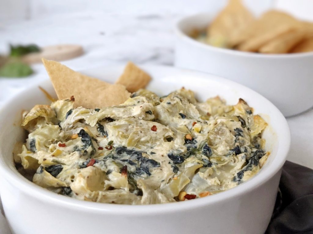 Cheesy but healthy Hot Spinach Artichoke Dip made with low fat cream cheese and Greek yogurt for the same amazing taste with lower calories! Serve this warm baked dip with tortilla chips for a delicious game day appetizer.