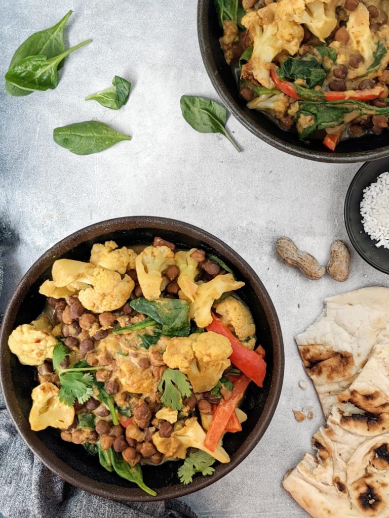 This super creamy Peanut Butter Chickpea Curry is full of rich peanut butter flavor, perfectly spiced, and loaded with cauliflower and spinach too. It requires one pot, comes together in under 30 minutes, and is so delicious, its definitely my new favorite curry!