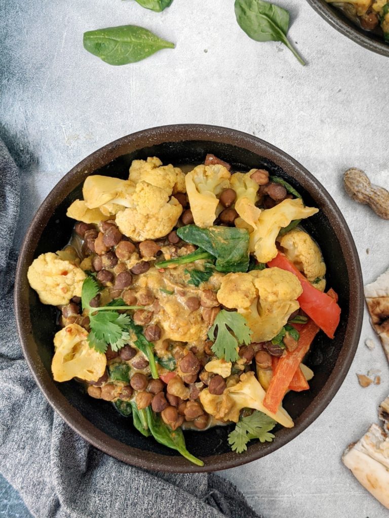 This super creamy Peanut Butter Chickpea Curry is full of rich peanut butter flavor, perfectly spiced, and loaded with cauliflower and spinach too. It requires one pot, comes together in under 30 minutes, and is so delicious, its definitely my new favorite curry!