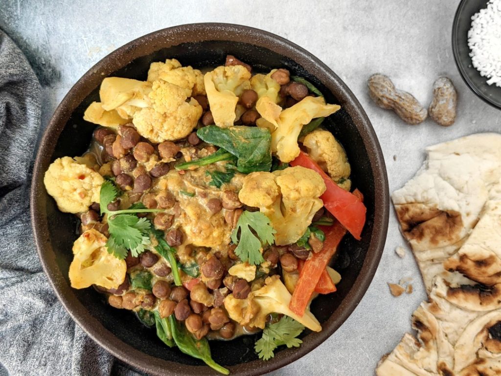 This super creamy Peanut Butter Chickpea Curry is full of rich peanut butter flavor, perfectly spiced, and loaded with cauliflower and spinach too. It requires one pot, comes together in under 30 minutes, and is so delicious, its definitely my new favorite curry!