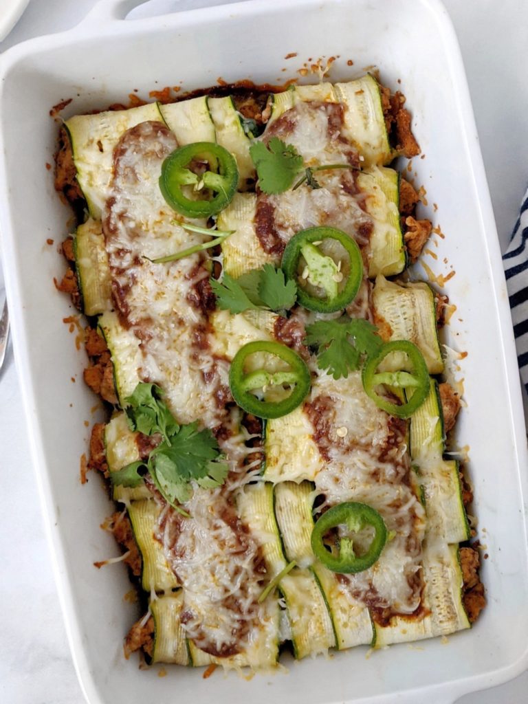 Cheesy protein-packed Turkey Zucchini Enchiladas with a homemade enchilada sauce. Using strips of zucchini and no tortillas, this enchilada recipe is great for a healthy, low carb, high protein dinner!