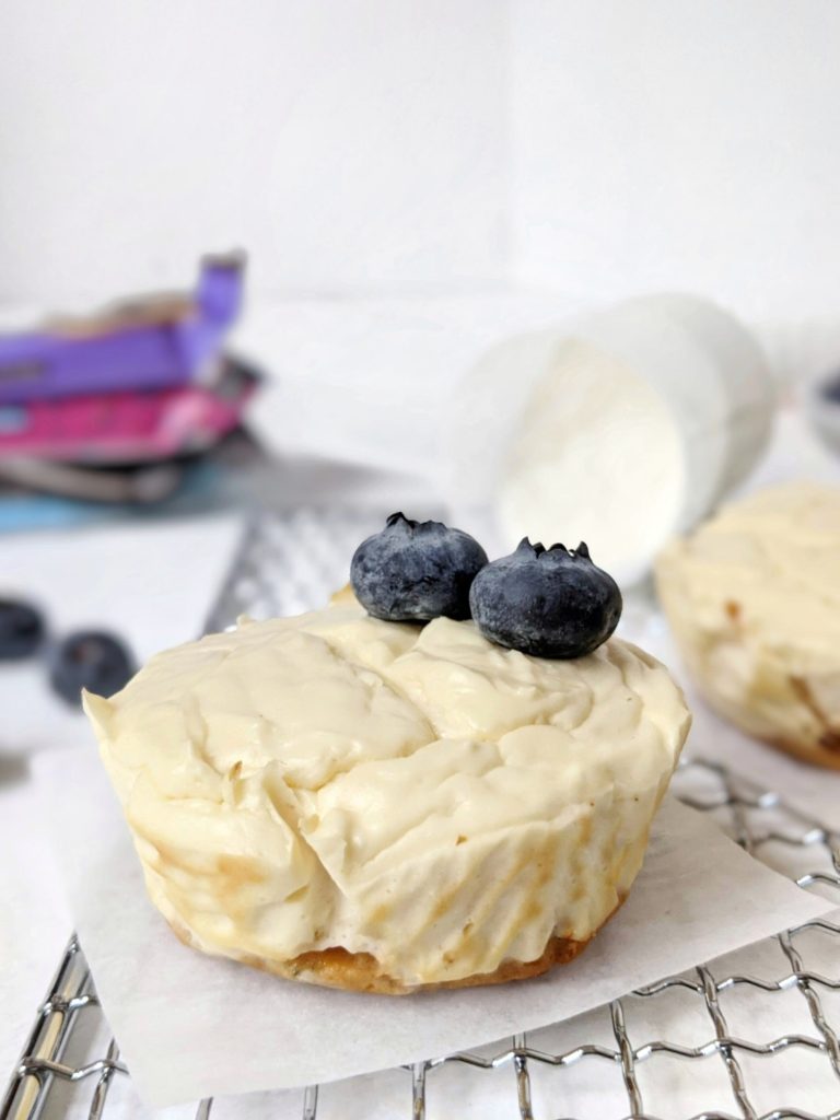 Mini Protein Cheesecakes with a Protein Bar Crust - easy, healthy, high protein cheesecake bites made with greek yogurt and protein powder, and a protein bar for the crust! These mini cheesecakes are made in a muffin tin and perfect for a single serve or small batch baking. Gluten-free and sugar-free too!