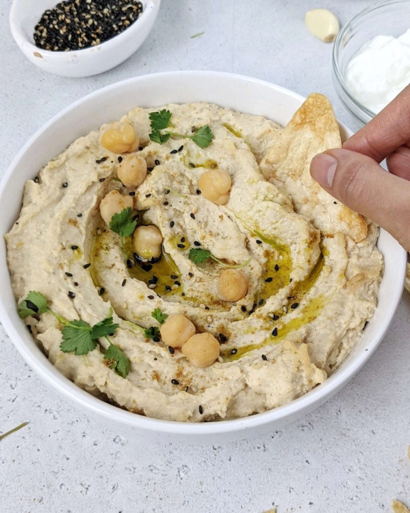 This recipe makes the Best Healthy Hummus with Greek Yogurt and Tahini, but no oil. A homemade high protein hummus that’s skinny, easy and delicious too! 