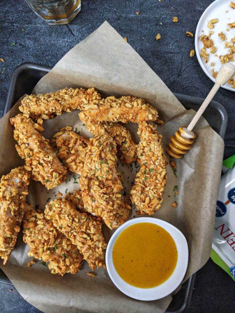 Crispy and crunchy, these Spicy Pretzel Chicken Tenders are baked in the oven or cooked in an air fryer - the best appetizer you can find. With no bread crumbs, these pretzel crusted chicken fingers are healthy and even more perfect with a honey mustard dipping sauce.