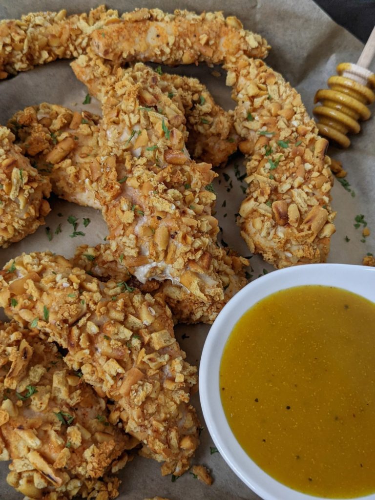 Crispy and crunchy, these Spicy Pretzel Chicken Tenders are baked in the oven or cooked in an air fryer - the best appetizer you can find. With no bread crumbs, these pretzel crusted chicken fingers are healthy and even more perfect with a honey mustard dipping sauce.