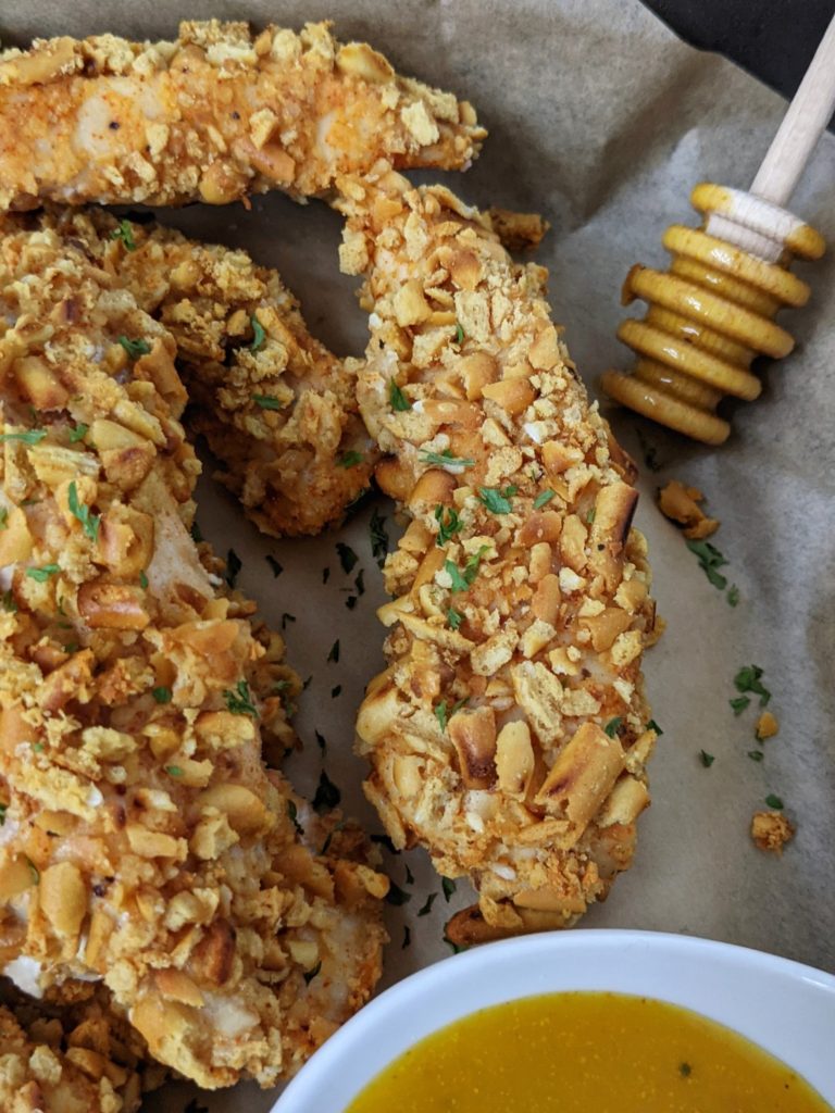 vCrispy and crunchy, these Spicy Pretzel Chicken Tenders are baked in the oven or cooked in an air fryer - the best appetizer you can find. With no bread crumbs, these pretzel crusted chicken fingers are healthy and even more perfect with a honey mustard dipping sauce.