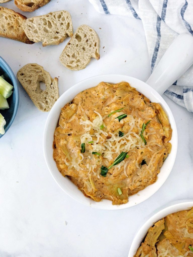 Baked Buffalo Chicken Artichoke Dip made with shredded chicken, Greek Yogurt and low sodium wing sauce really is the best healthy dip you can get. A low calorie skinny buffalo chicken dip with artichoke for volume and nutrition perfect for a super bowl appetizer.