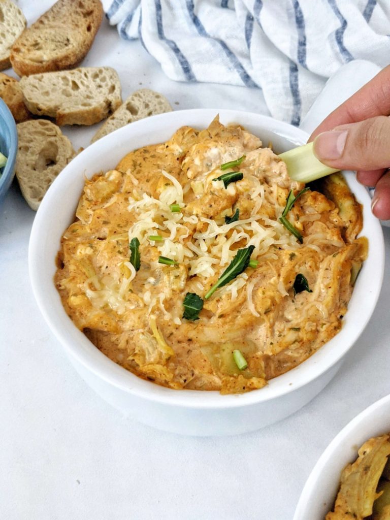 Baked Buffalo Chicken Artichoke Dip made with shredded chicken, Greek Yogurt and low sodium wing sauce really is the best healthy dip you can get. A low calorie skinny buffalo chicken dip with artichoke for volume and nutrition perfect for a super bowl appetizer.