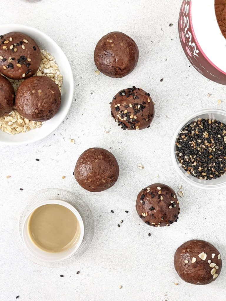 Super simple Chocolate Tahini Protein Balls that taste like soft dark chocolate truffles! Made with tahini, oat, protein powder and cacao, these easy no bake Tahini protein balls have a Keto option too.