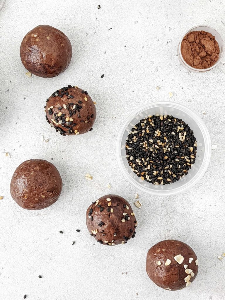 Super simple Chocolate Tahini Protein Balls that taste like soft dark chocolate truffles! Made with tahini, oat, protein powder and cacao, these easy no bake Tahini protein balls have a Keto option too.