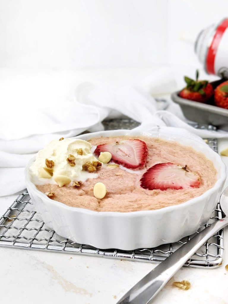 A high protein Strawberry Baked Oatmeal for One: Sweetened with protein powder and made creamy with greek yogurt, this strawberry protein baked oats is a healthy breakfast recipe that tastes just like a strawberries and cream dessert!