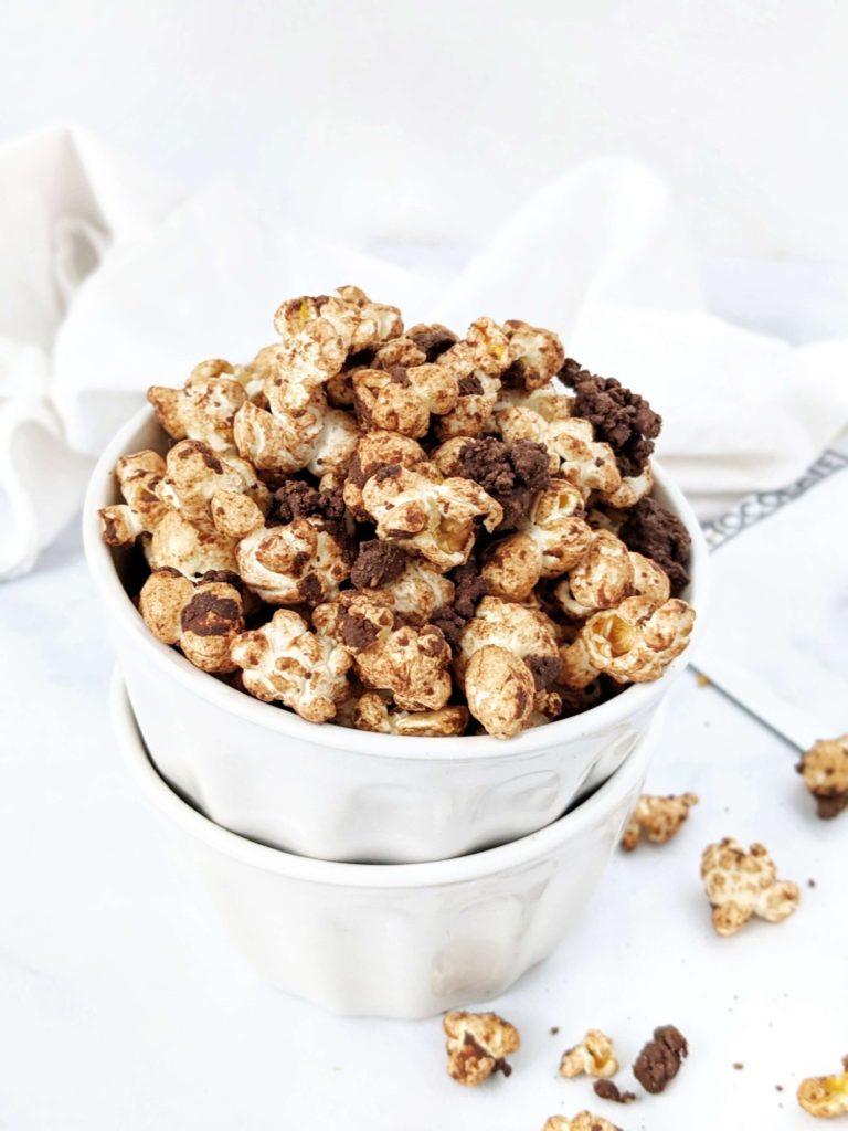 The best double Chocolate Protein Popcorn recipe complete with dark chocolate protein crumbles! This chocolate covered protein popcorn uses protein powder, melted chocolate and almond butter and is quite the perfect high protein snack or dessert.