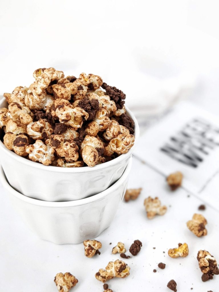 The best double Chocolate Protein Popcorn recipe complete with dark chocolate protein crumbles! This chocolate covered protein popcorn uses protein powder, melted chocolate and almond butter and is quite the perfect high protein snack or dessert.