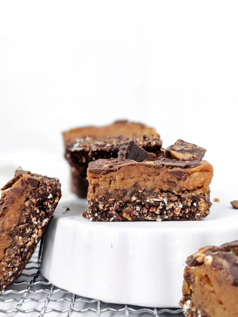 Soft and chewy Peanut Butter Cup Protein Bars with all the chocolate and peanut butter flavor, and topped with chopped PB cups, but gluten free, sugar free and high protein; A much healthier and better option than Reese’s candy!