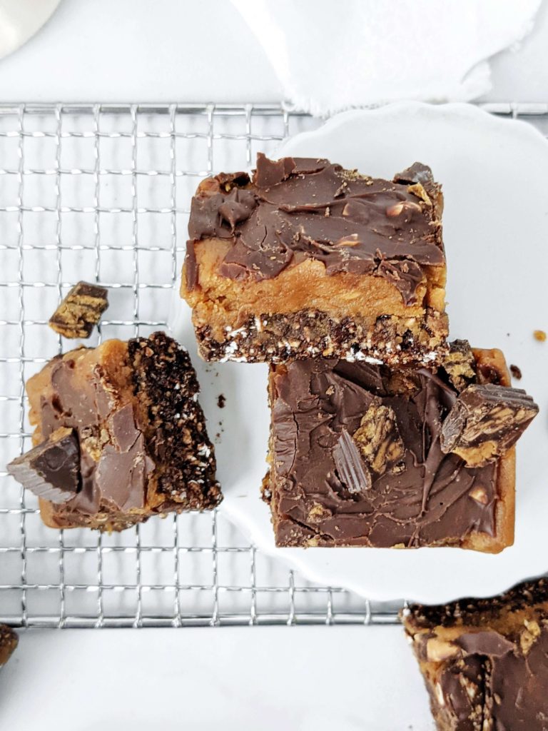 Soft and chewy Peanut Butter Cup Protein Bars with all the chocolate and peanut butter flavor, and topped with chopped PB cups, but gluten free, sugar free and high protein; A much healthier and better option than Reese’s candy!